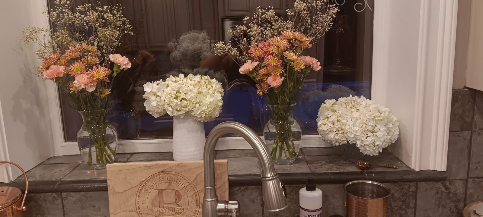 Kitchen windowsill with fresh flower arrangements