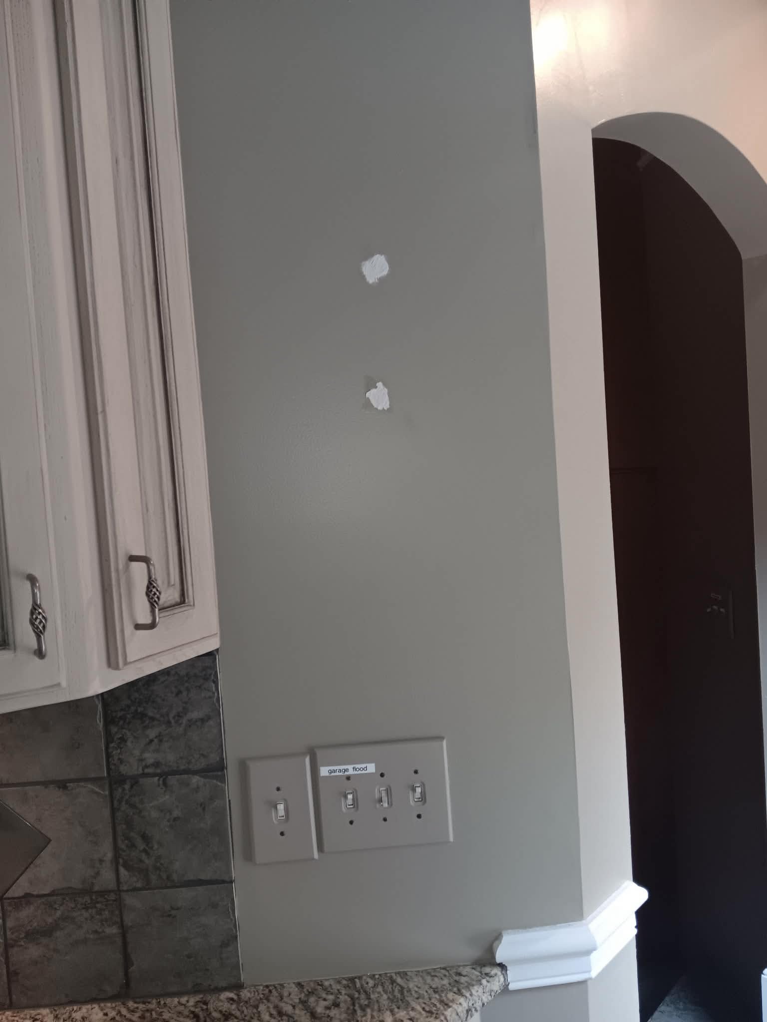 Before — wall with patched holes