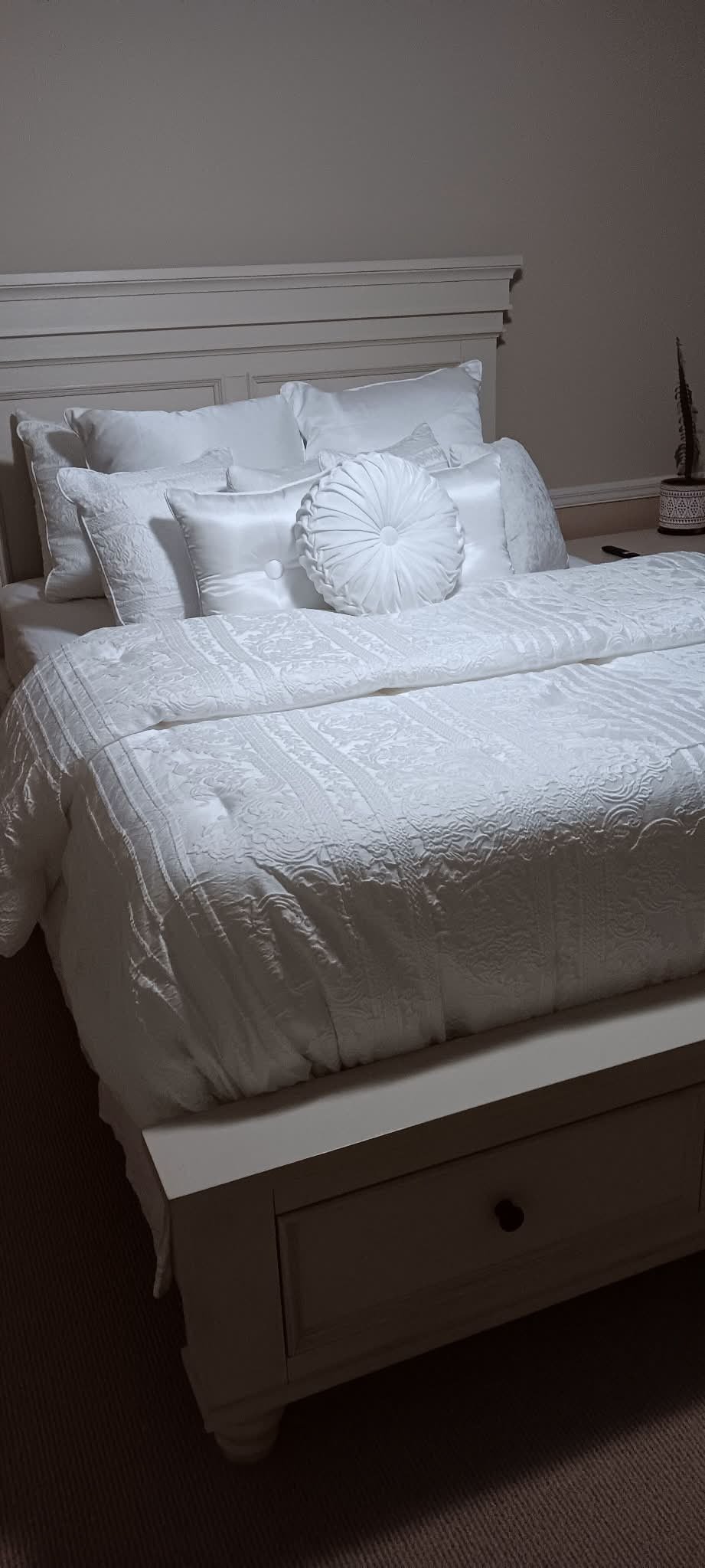 Crisp white bedroom with storage bed