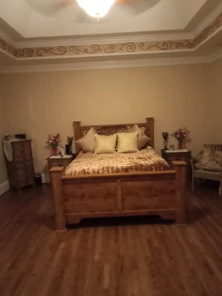 Styled master bedroom with tray ceiling